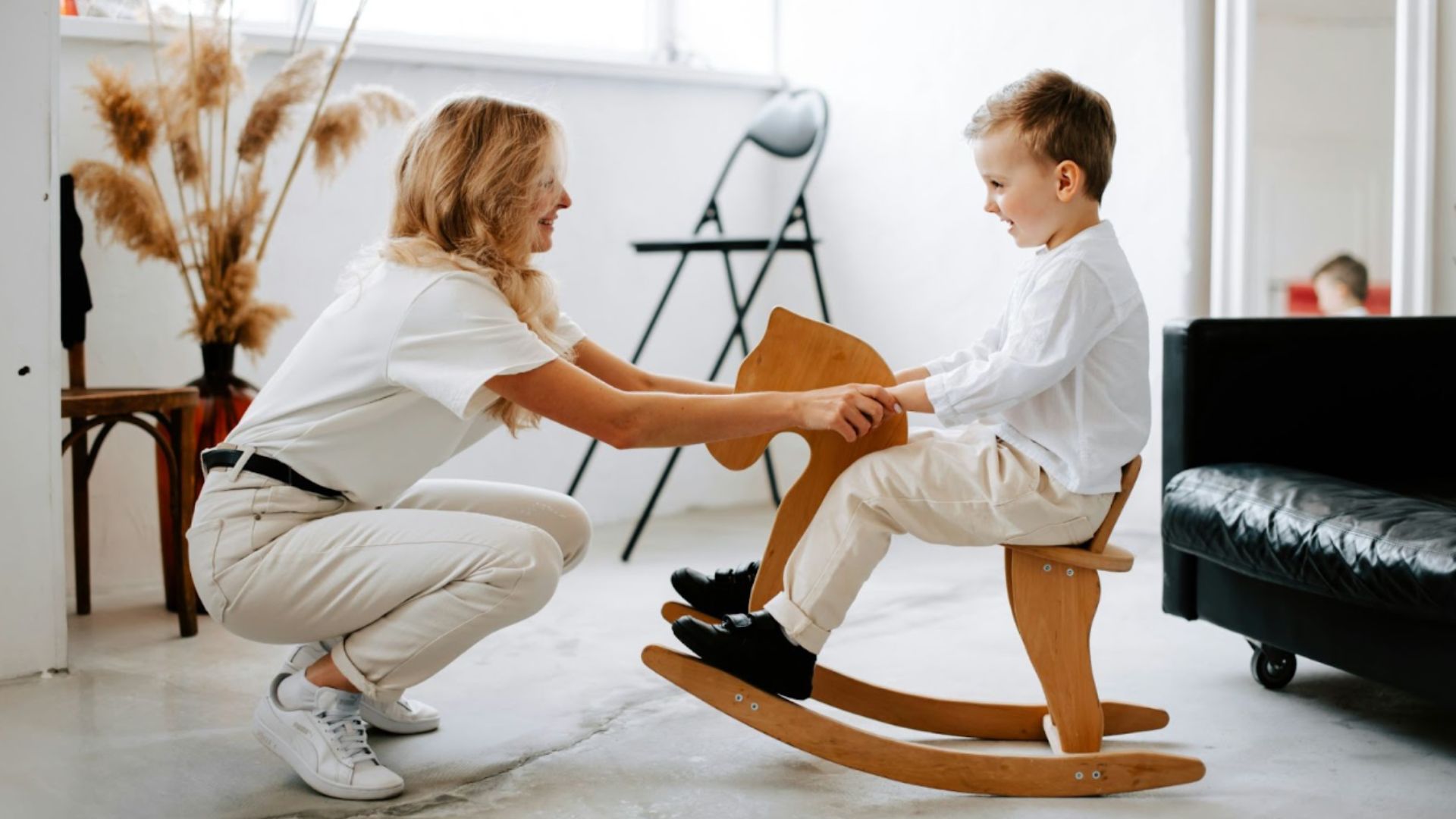 A parent plays with her child after child therapy session in Ontario.